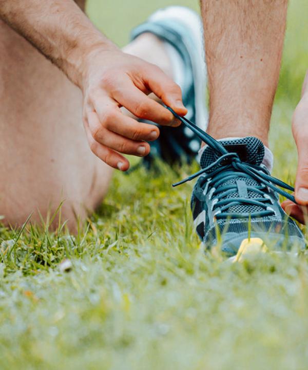 Close up of man tying shoelaces