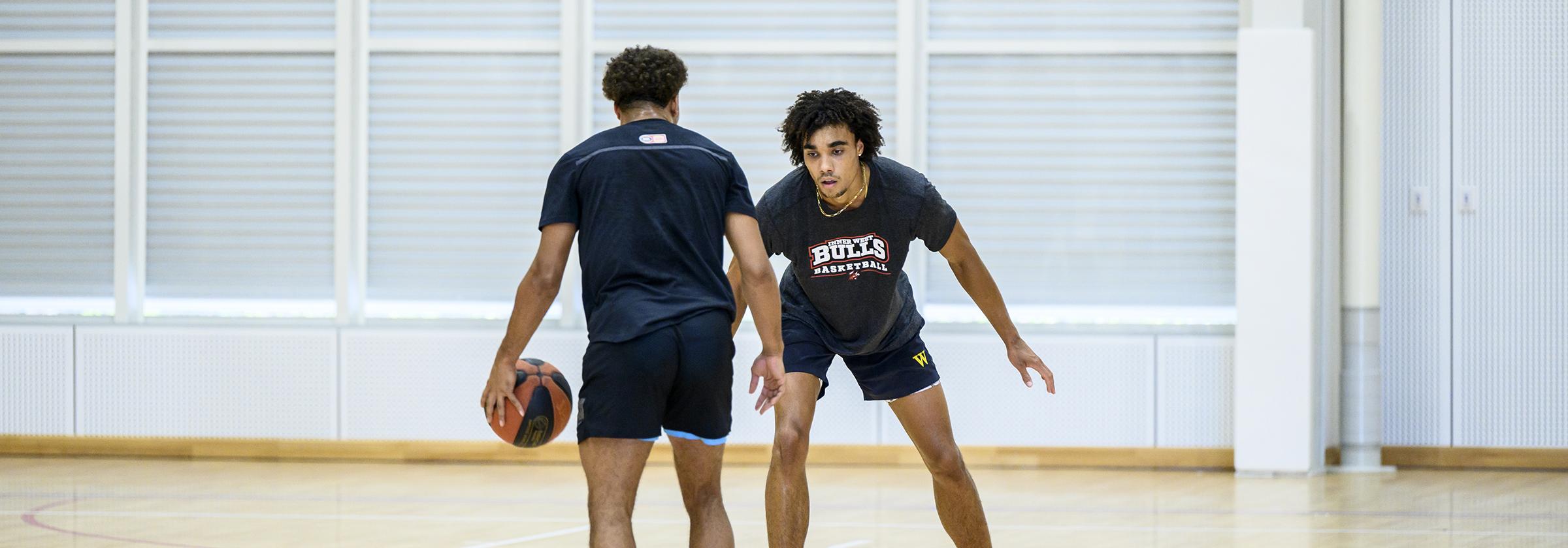 Two men playing basketball