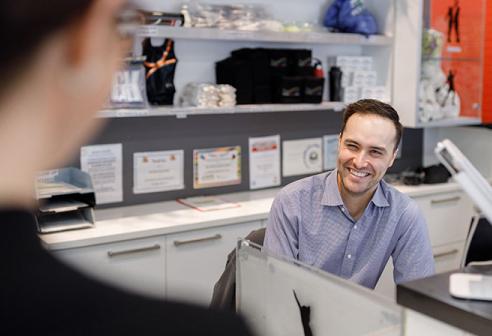 Staff member behind front desk